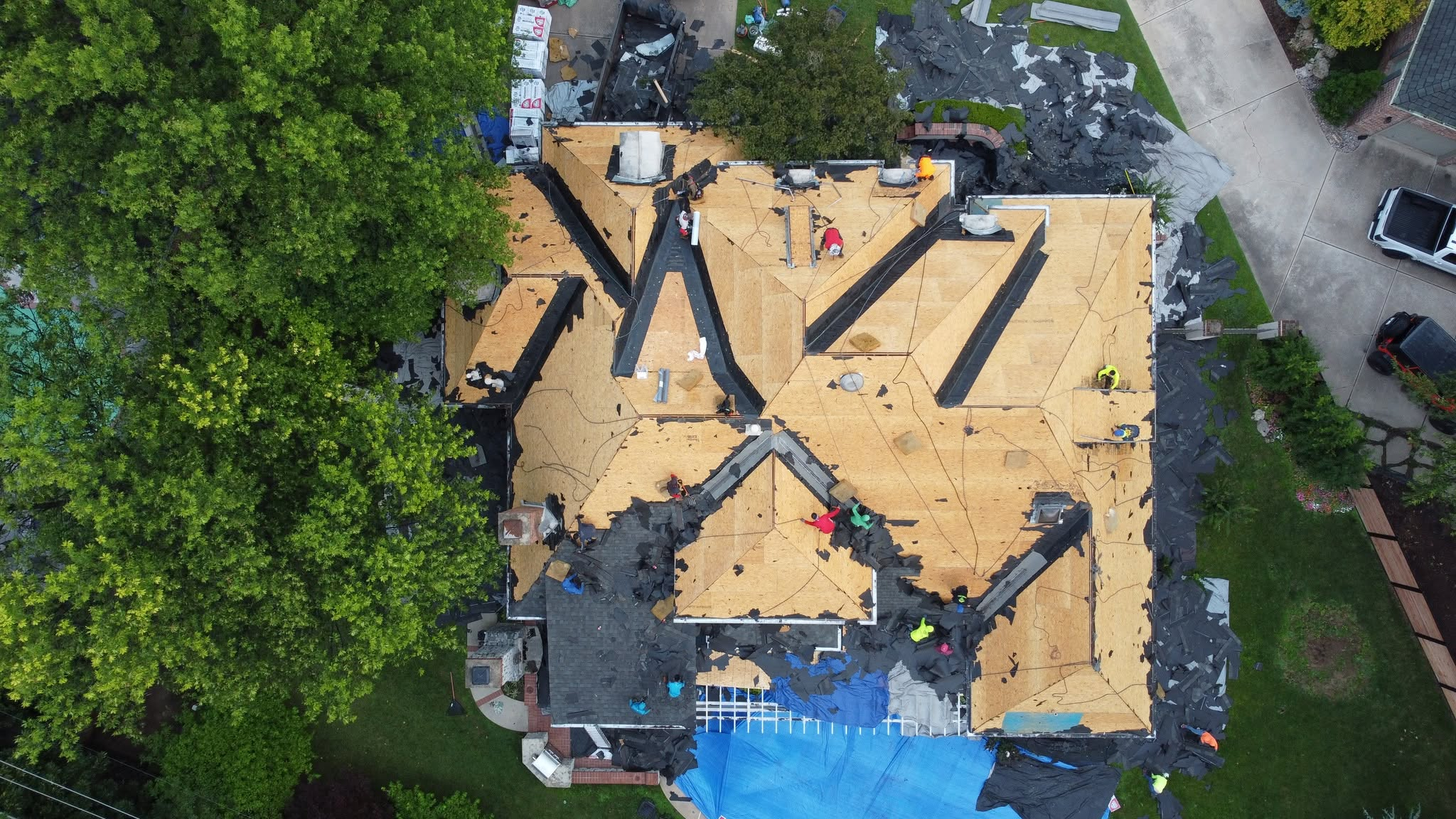 Aerial view of a roof stripped to the wood decking during a roof replacement