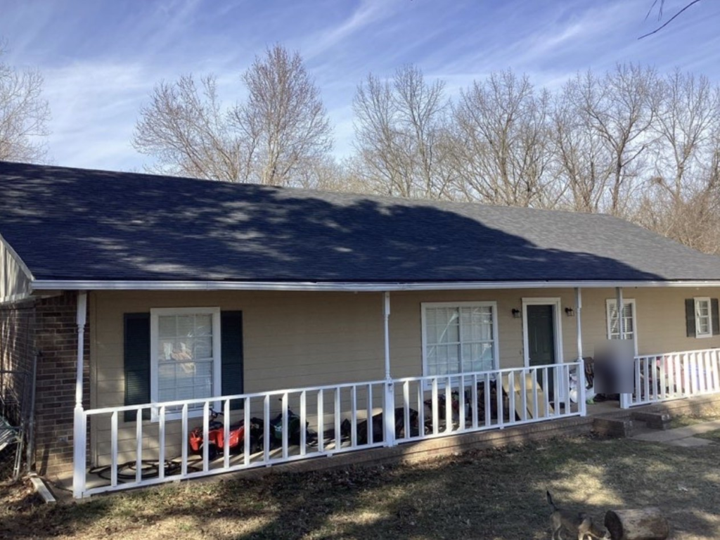 Finished roof replacement on a single-story ranch home with a covered front porch in Coweta