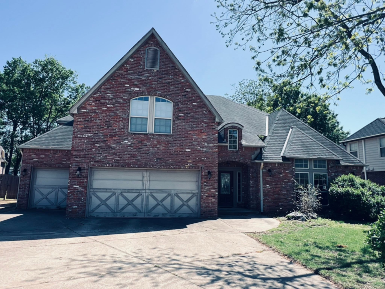 Completed roof on a brick home with a front gable