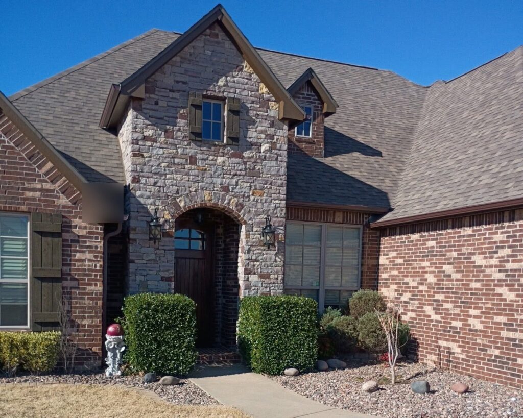Completed roof on a stone and brick home