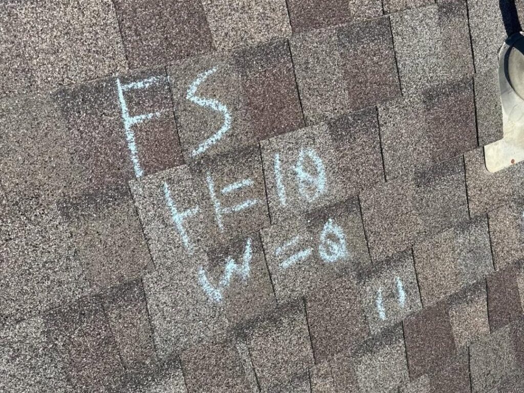 Chalk test square marked on a roof during a hail inspection